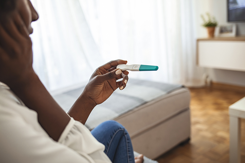 Woman looking at pregnancy test
